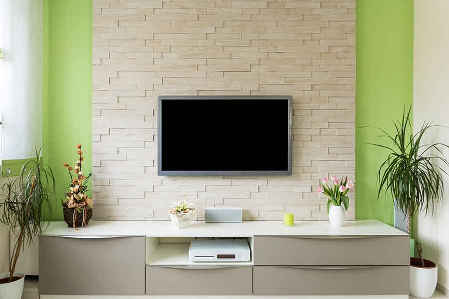 flat screen tv mounted on wall using bracket
