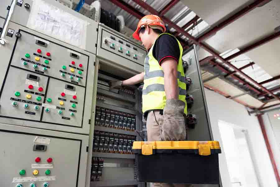 electrician conducting maintenance on electrical facilities